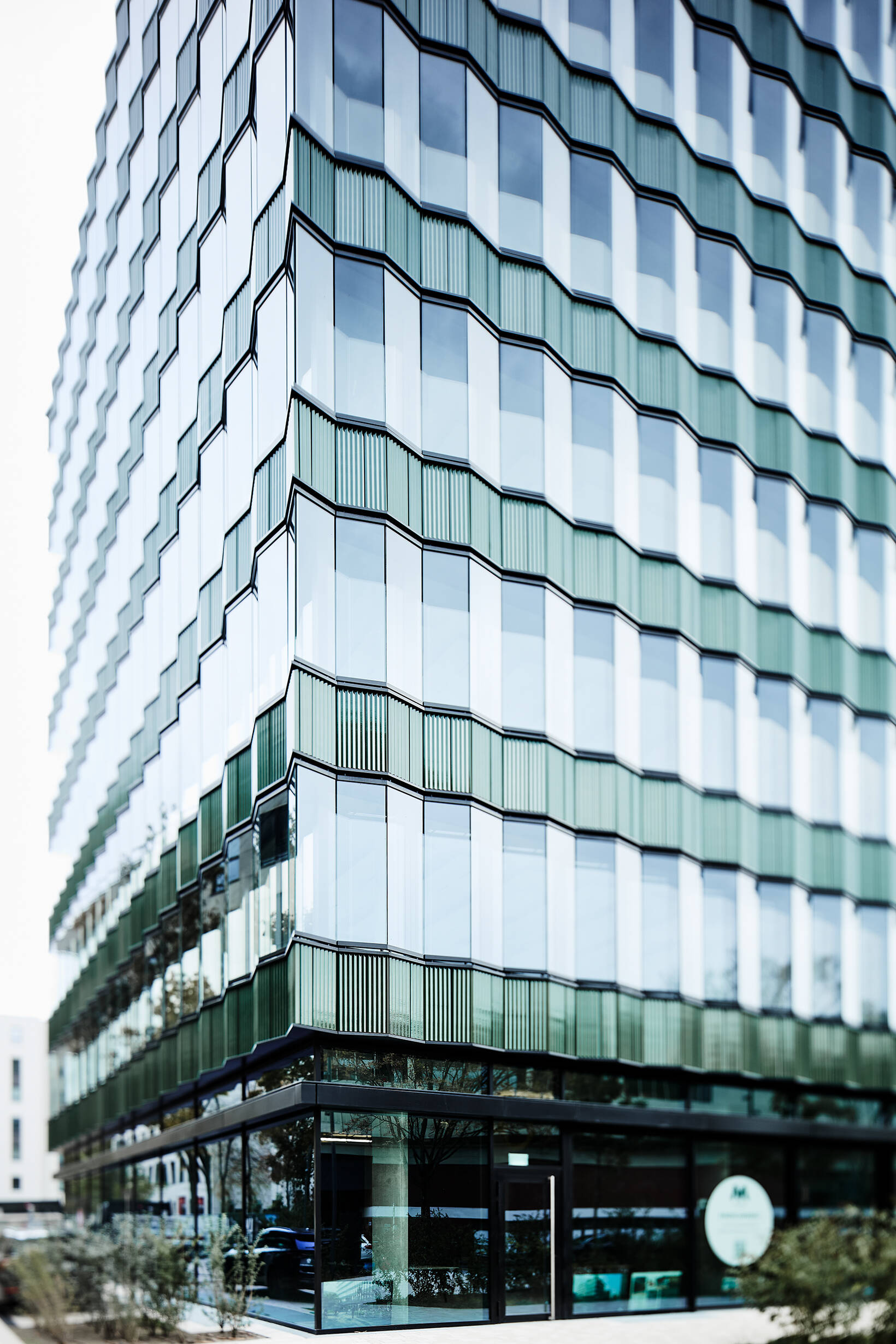 A modern brick building at Die Macherei Berlin featuring expansive ISOLAR glass facades that blend industrial heritage with contemporary design.