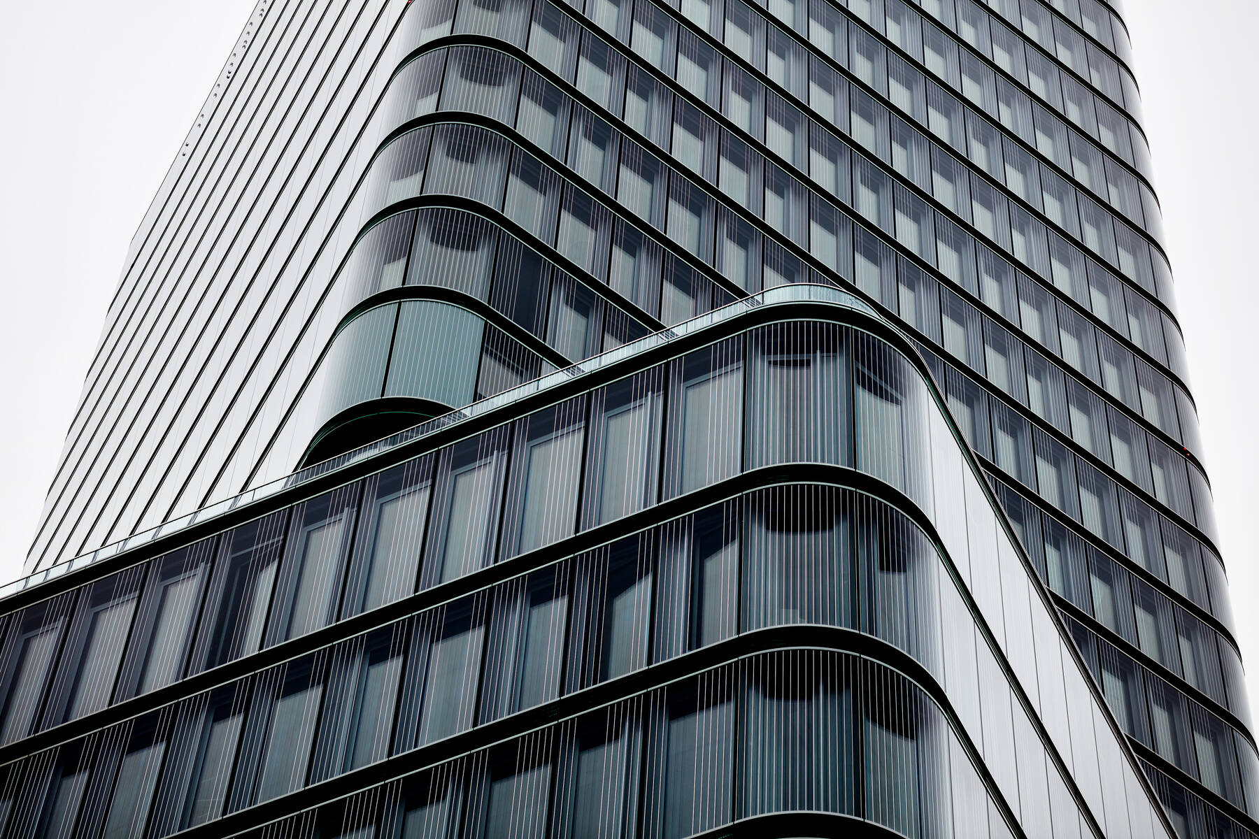 The Porsche Design Tower in Stuttgart utilizes ISOLAR glass for its striking, high-quality facade design, representing the fusion of design, innovation, and technical precision.