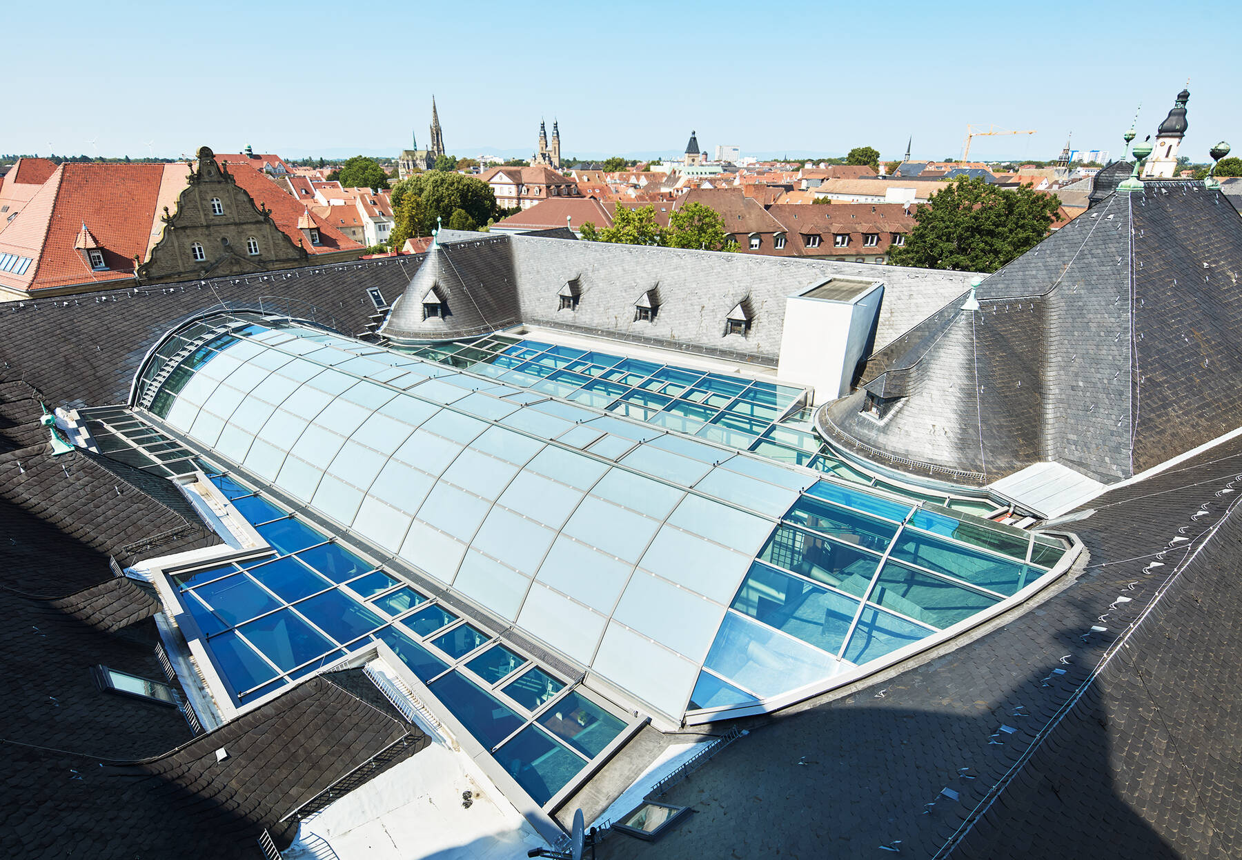 Interior view of the museum in sunlight; the ISOLAR glass surfaces create a soft, diffused play of light on the museum walls.