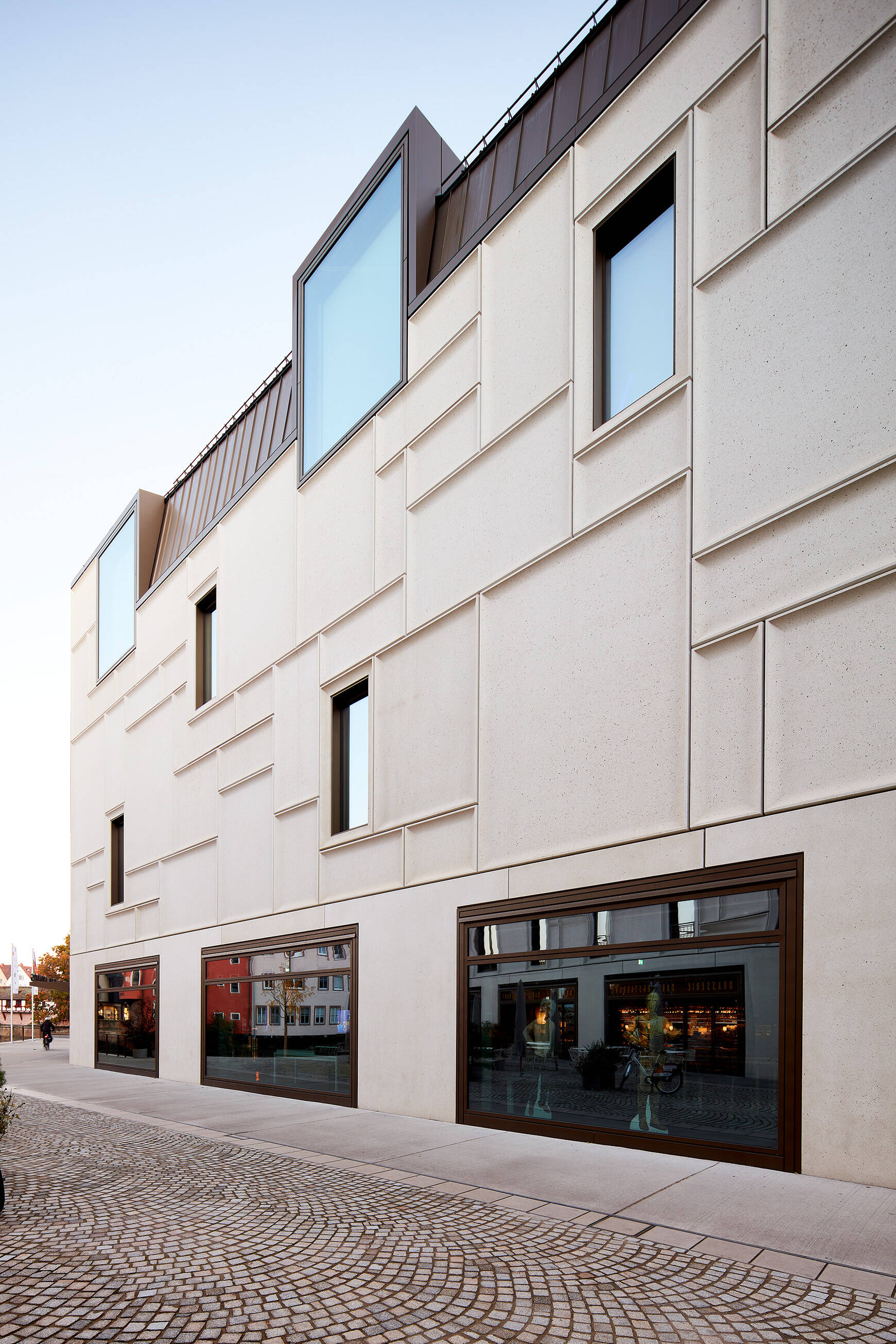 Architectural view of the Augustinerhof in Nuremberg featuring a modern ISOLAR glass facade and clean architectural lines.