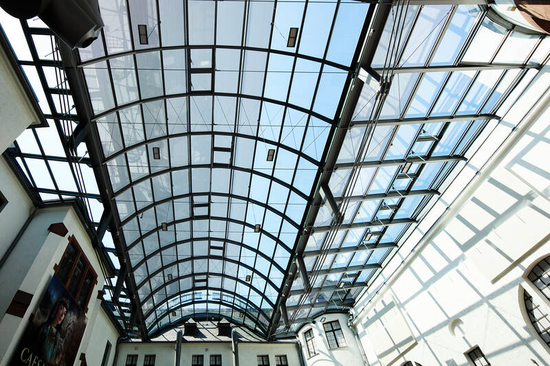 Exterior view of the Historical Museum of the Palatinate in Speyer, where modern glass architecture blends harmoniously with the historic building fabric.